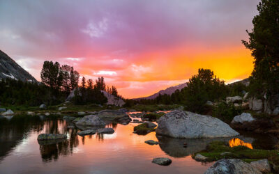 a serene scene of a sunset over a lake