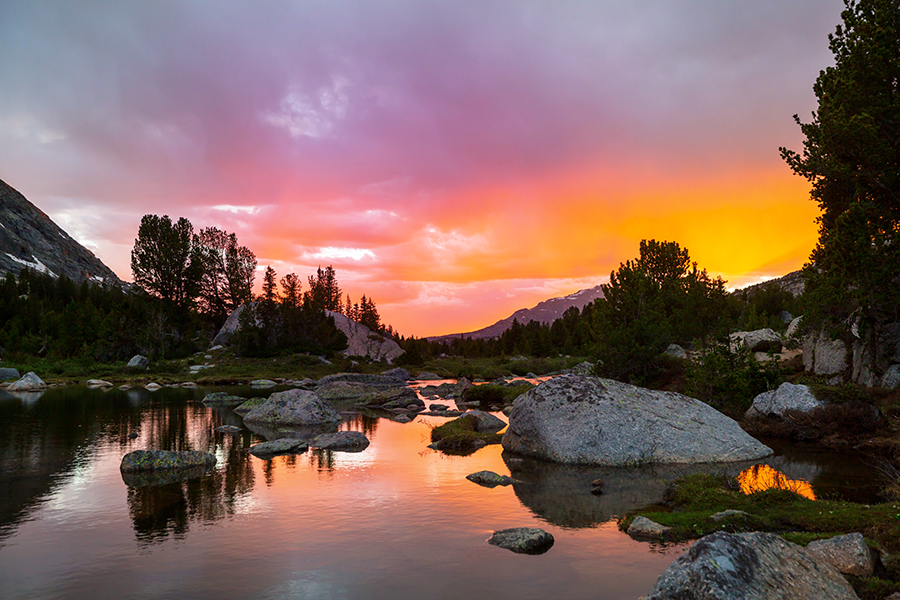 a serene scene of a sunset over a lake