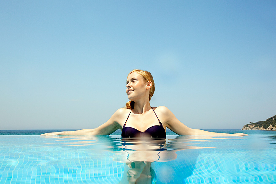 woman in a pool on a hot sunny day